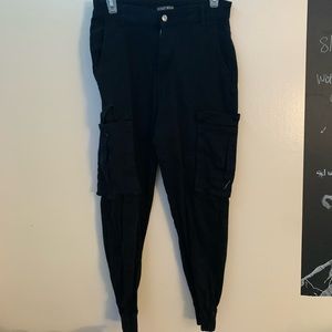 black cargo pants. pockets going down the sides.